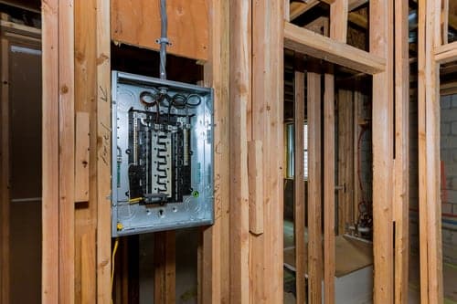 Electrician installing a residential breaker panel during an electrical service upgrade in Palmdale, California