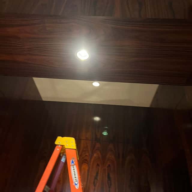 Recessed ceiling light fitted in a wood ceiling panel during a commercial lighting install — Nebady's Electric Corporation, Palmdale, CA