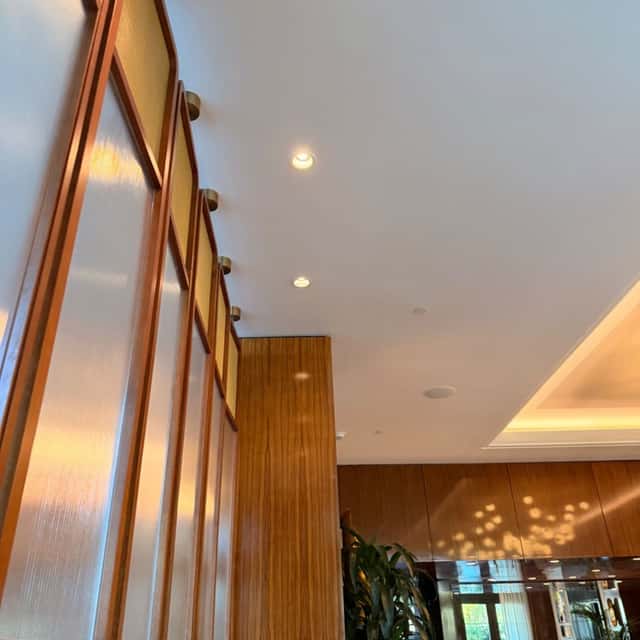 Wall sconce lighting along a wood-panelled lobby wall — Nebady's Electric Corporation, Palmdale, CA