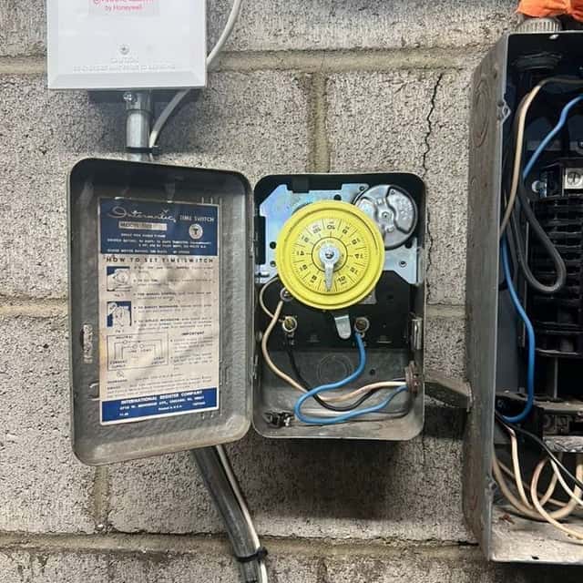 Electric meter socket, timer and service equipment on a block wall — Nebady's Electric Corporation, Palmdale, CA