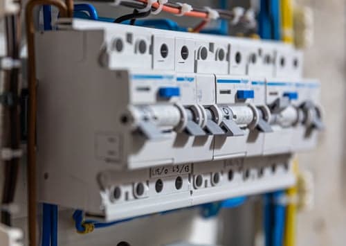 Licensed electrical contractor working on a commercial electrical distribution board in Southern California